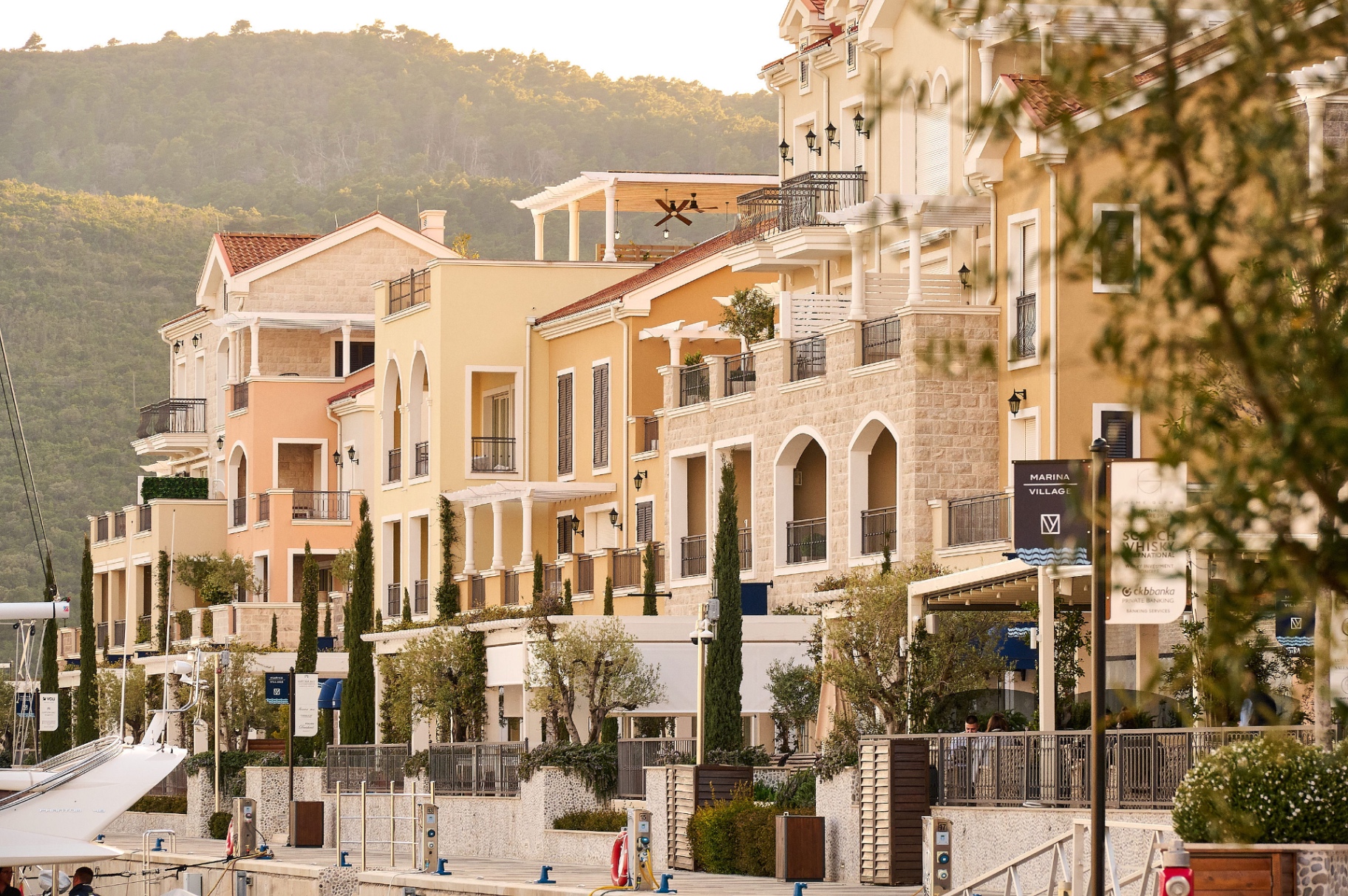Marina Village at golden hour - waterfront residences, marina and yachts at Luštica Bay, Montenegro