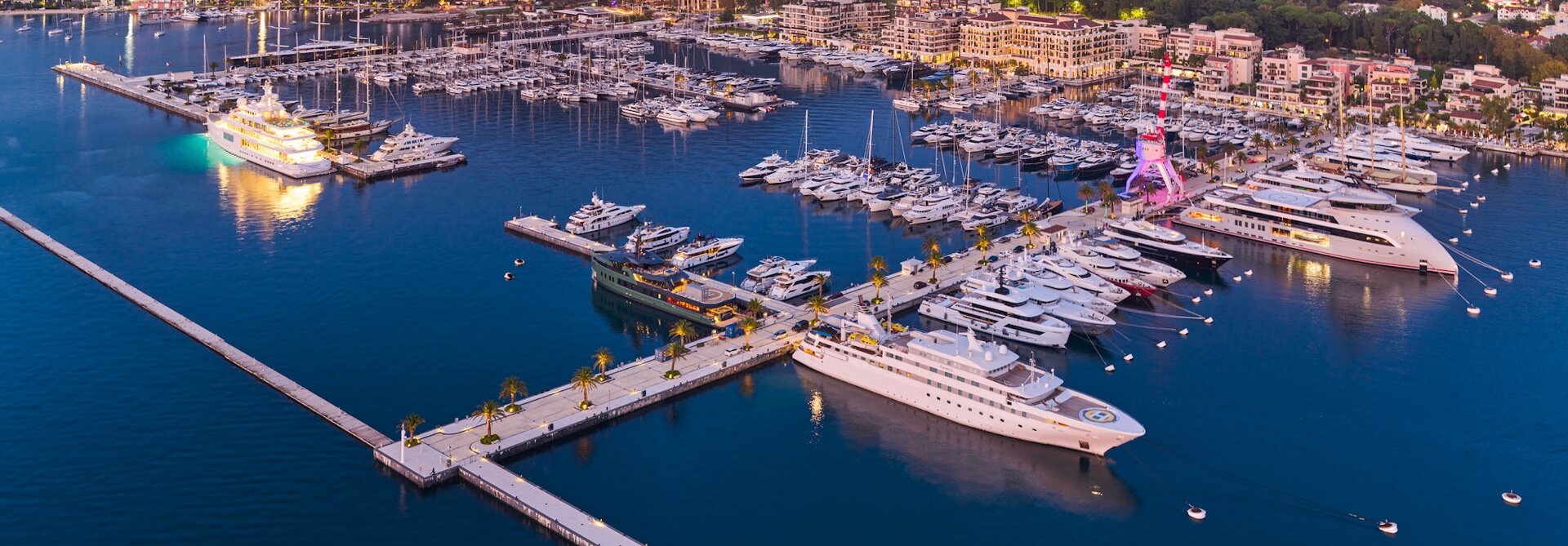 Aerial view of Porto Montenegro marina at dusk with superyachts berthed in Tivat, Bay of Kotor, Montenegro